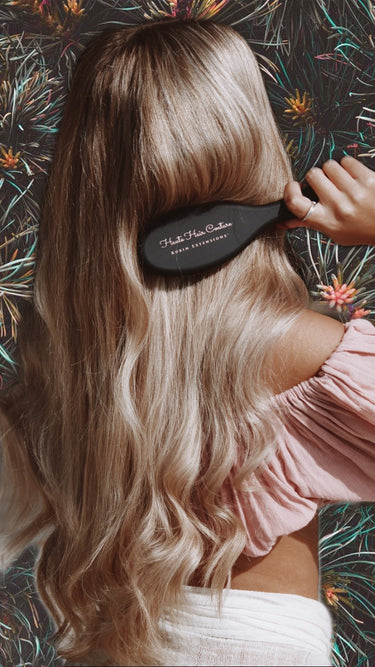 Using the gold hair brush to comb human hair extensions – Rubin Extensions®